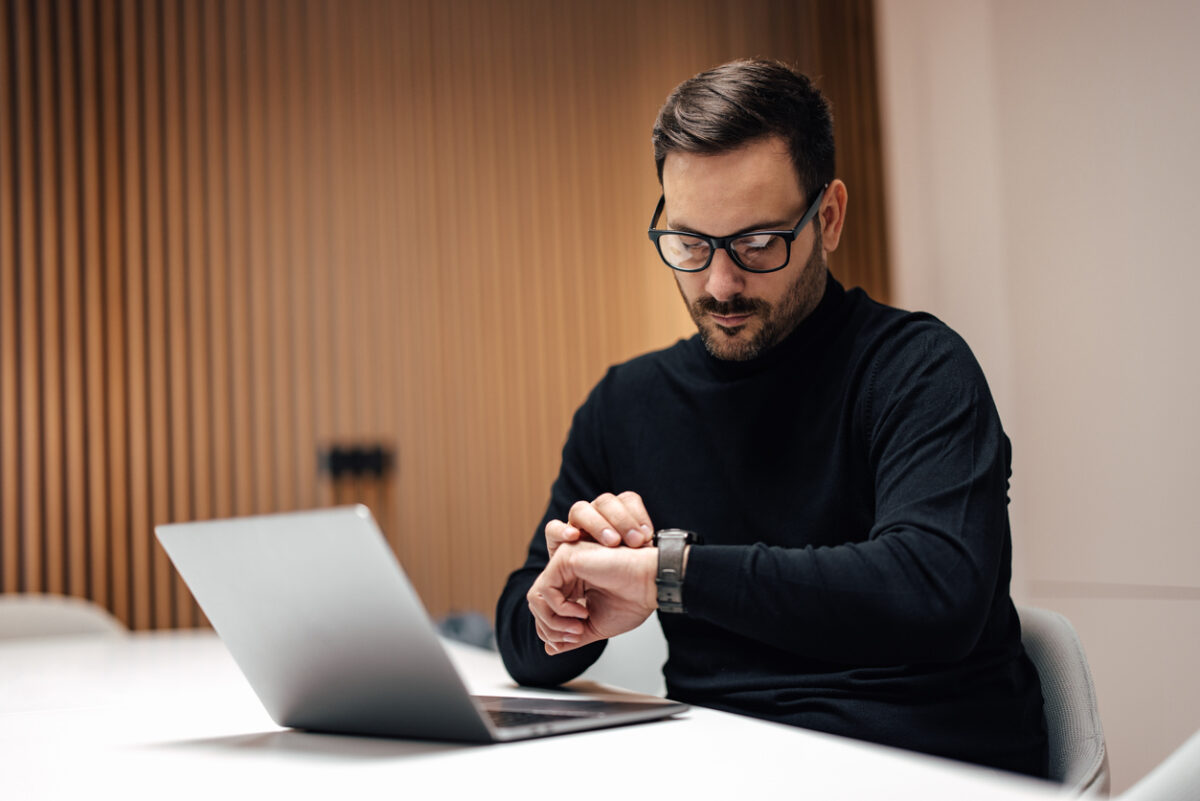 A man choosing the best time to send an email campaign.