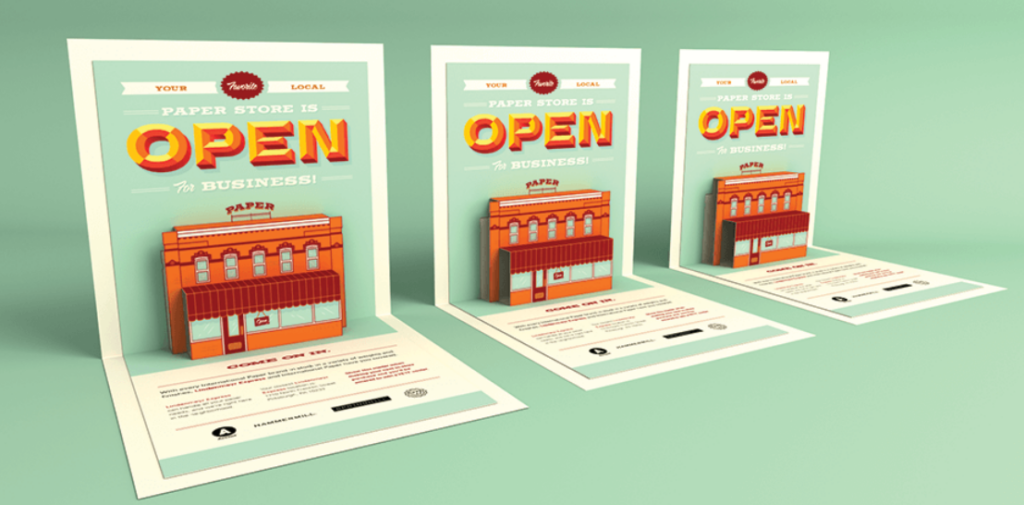 Three colorful fold out posters in an open store, designed to attract customers with engaging visuals and information.