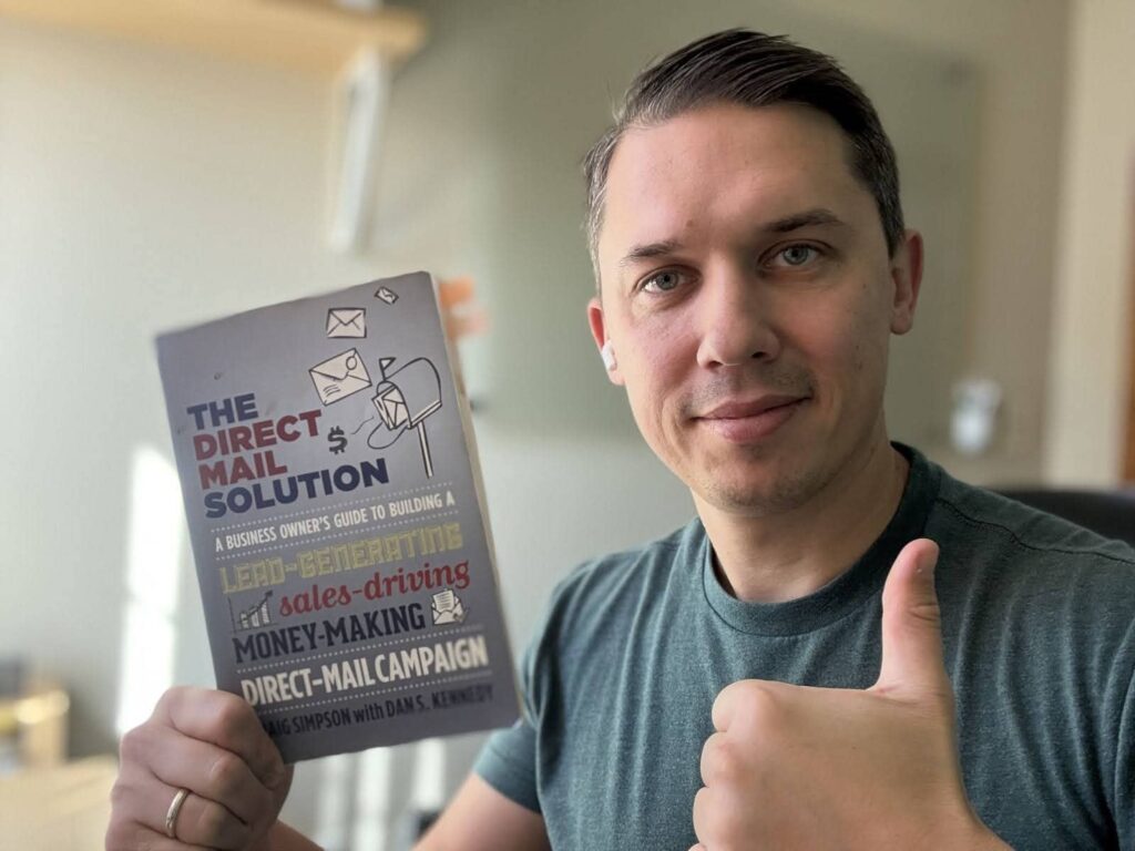 Andriy Boychuk holding a book "The direct mail solution".