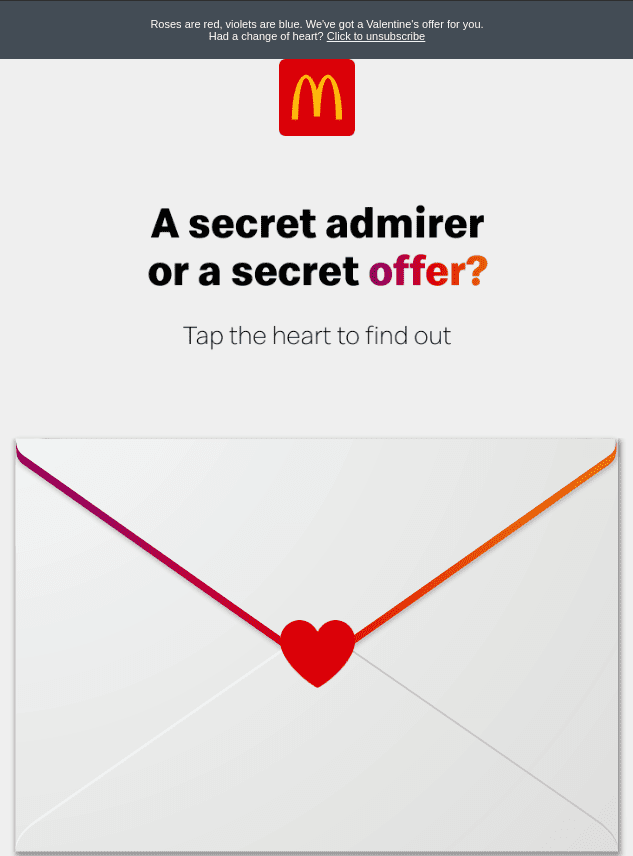A festive McDonald's display promoting a Valentine's Day Mystery Deal with heart-themed decorations and menu items.
